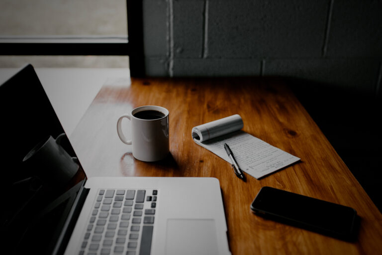 Laptop with coffee and a notepad Darker